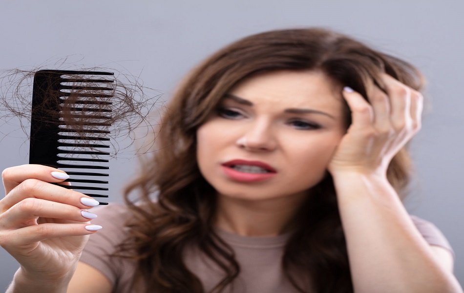 Close-up Of A Worried Woman Holding Comb Suffering From Hairloss